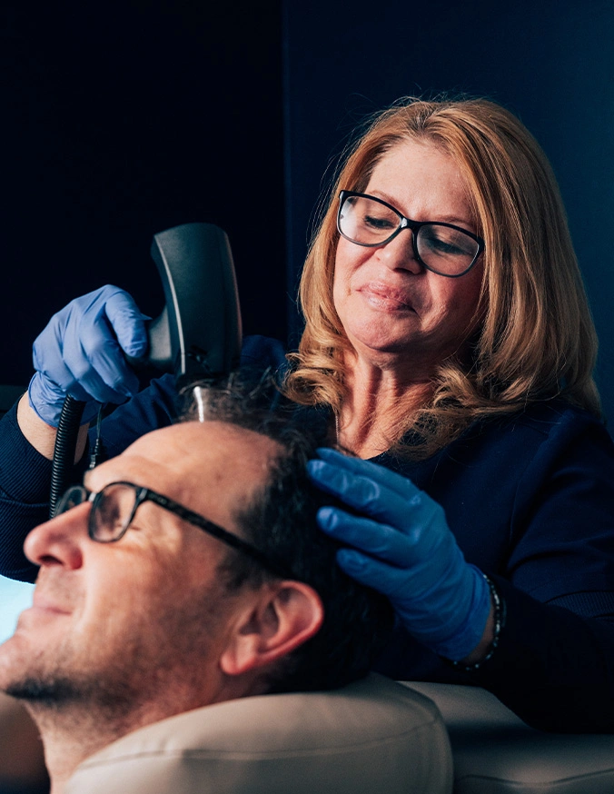 Eye care professional performing retinal imaging scan on male patient wearing protective eyewear - Alma TED in Wayne, PA