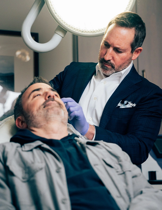 Doctor Morganstern MD examining male patient in modern medical chair under examination light - Exosomes in Wayne, PA