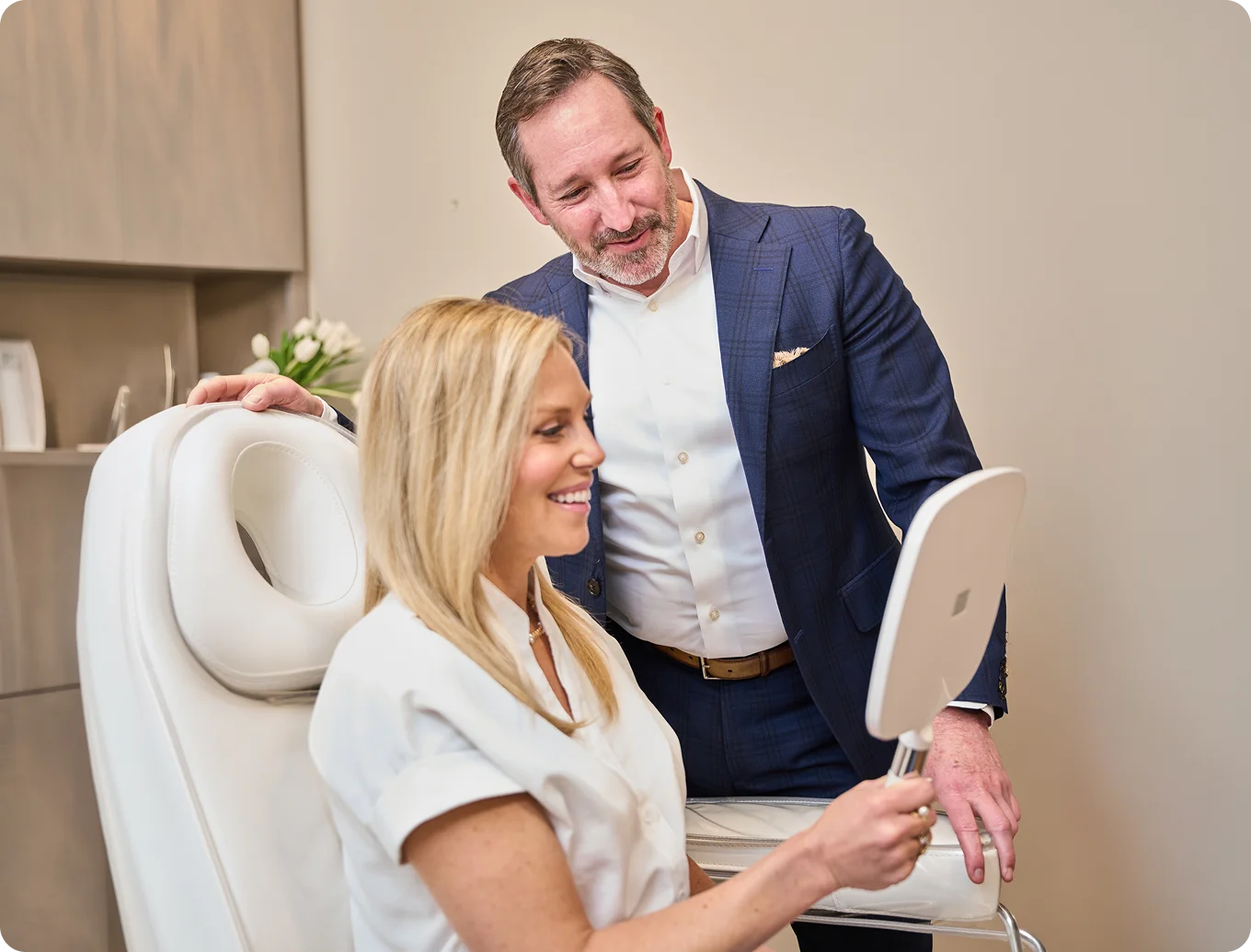 Doctor Morganstern MD consulting with female patient in modern medical office chair discussing treatment options - Face in Wayne, PA